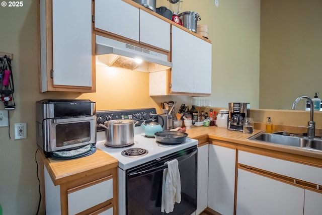 kitchen with white cabinetry, sink, and electric range