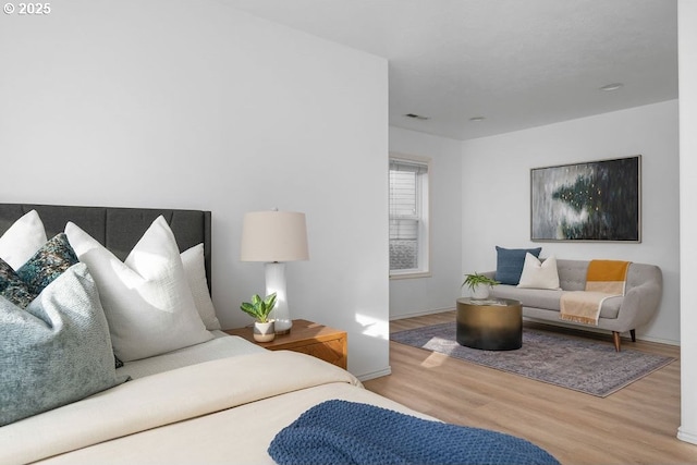 bedroom featuring visible vents and wood finished floors