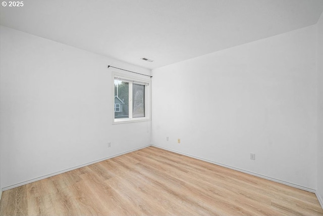 spare room with visible vents and wood finished floors