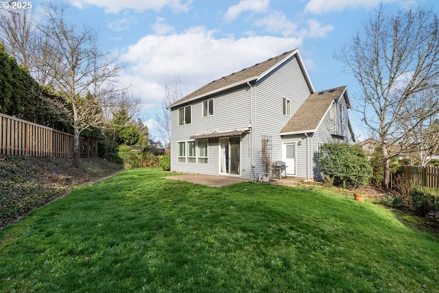 rear view of property with a yard, fence, and a patio