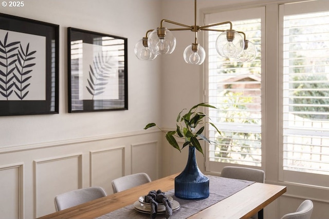 dining room featuring a decorative wall and wainscoting