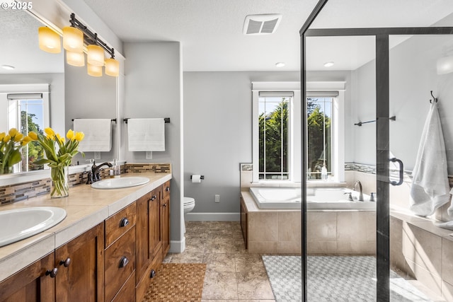 full bath featuring baseboards, double vanity, a bath, toilet, and an enclosed shower