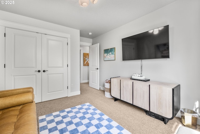 bedroom with light carpet, baseboards, and a closet