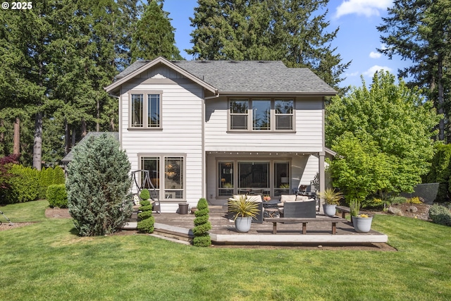 rear view of property featuring a wooden deck, a lawn, an outdoor living space, and a shingled roof