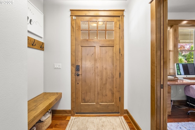 entryway featuring wood finished floors and baseboards