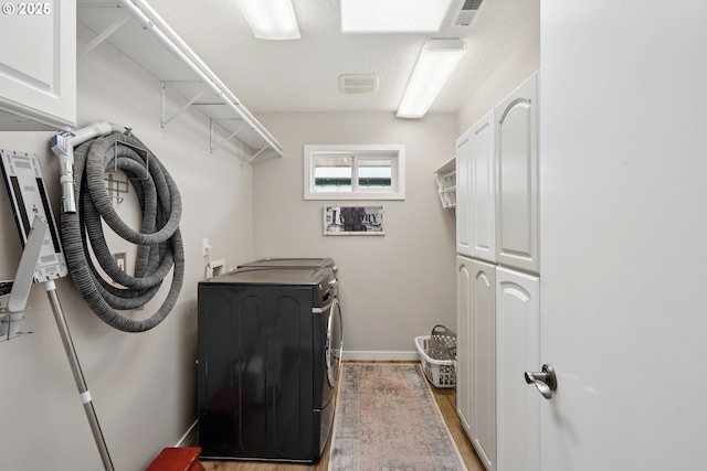 14587 NW Larson Rd Unit 4, Portland, OR 97231 - laundry room with independent washer and dryer, cabinet space, and light wood-style floors