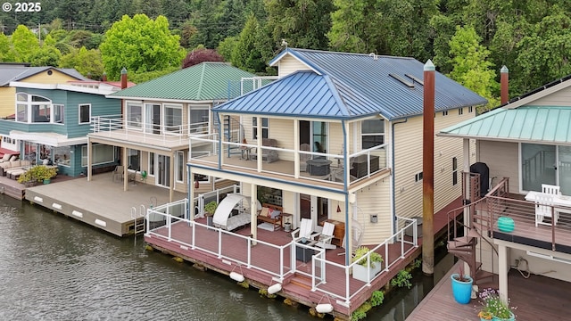14587 NW Larson Rd Unit 4, Portland, OR 97231 - rear view of property with a standing seam roof, a metal roof, a deck with water view, and a wooded view