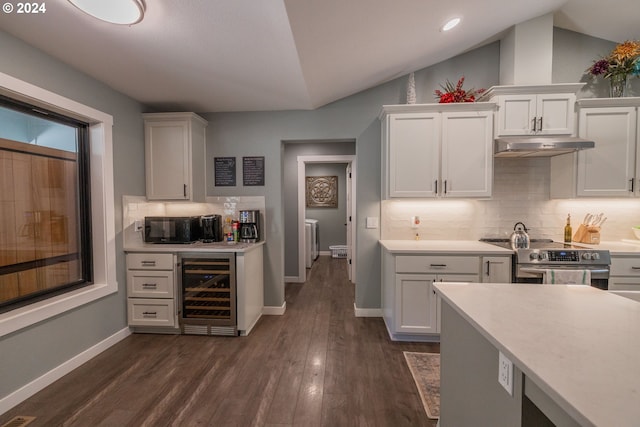 kitchen featuring under cabinet range hood, stainless steel electric range oven, beverage cooler, and light countertops