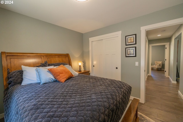 bedroom with wood finished floors and baseboards