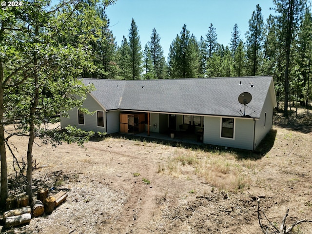 single story home featuring driveway and a shingled roof