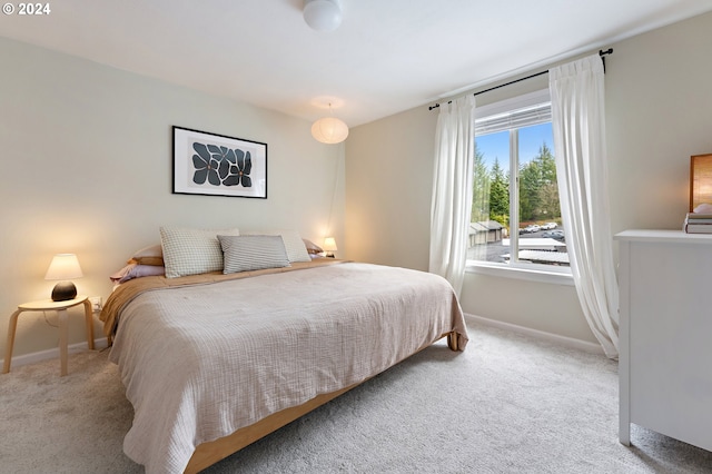 bedroom featuring light carpet