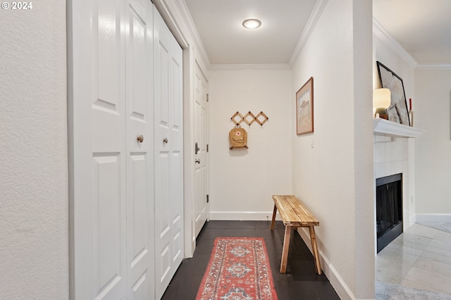 corridor with dark tile patterned flooring and crown molding