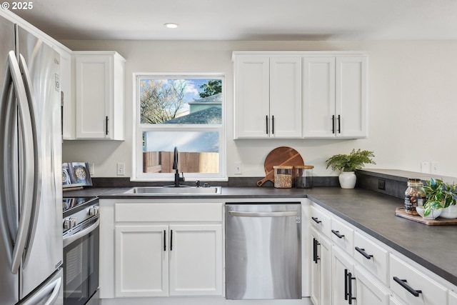 210 Mill St, Dayton, OR 97114 - kitchen featuring appliances with stainless steel finishes, dark countertops, white cabinetry, and recessed lighting