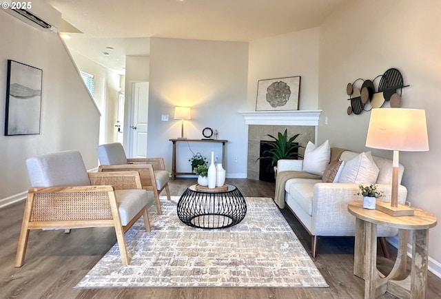 12972 SE 156th Ave, Happy Valley, OR 97086 - living area featuring wood finished floors, baseboards, and a tiled fireplace