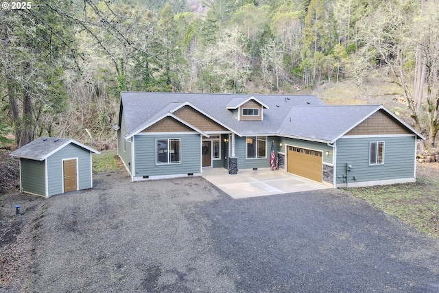 view of front of home with a garage and a storage unit