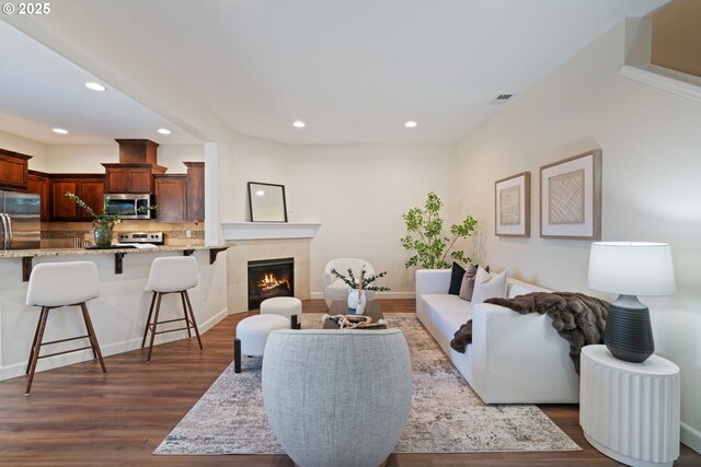 16085 SE Kingbird Dr, Clackamas, OR 97015 - living room with dark wood-style flooring, recessed lighting, and a tiled fireplace