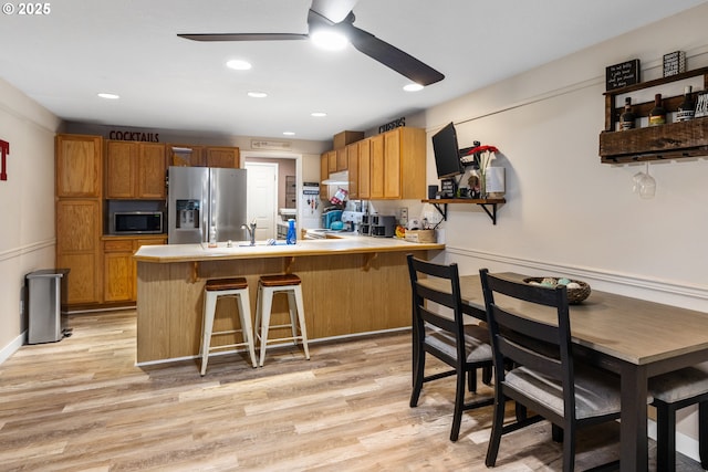 816 SW Chablis Ct, Dundee, OR 97115 - kitchen with stainless steel appliances, a ceiling fan, open shelves, a peninsula, and light wood finished floors
