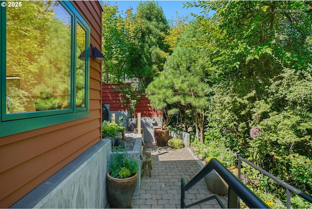 view of home's exterior featuring a patio area and fence