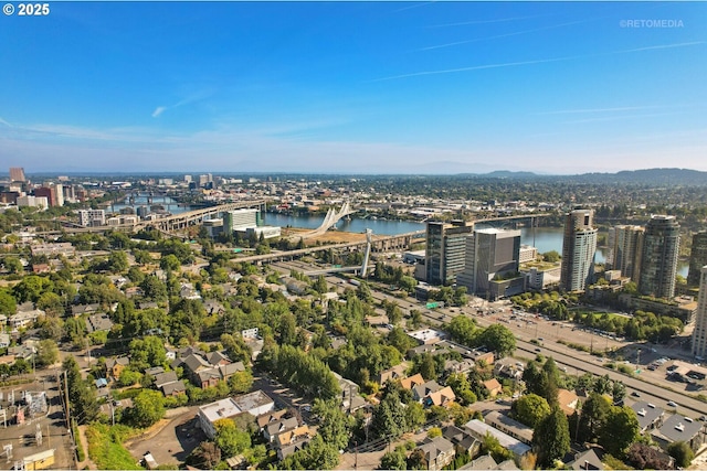 aerial view of property's location featuring a nearby body of water and nearby urban area
