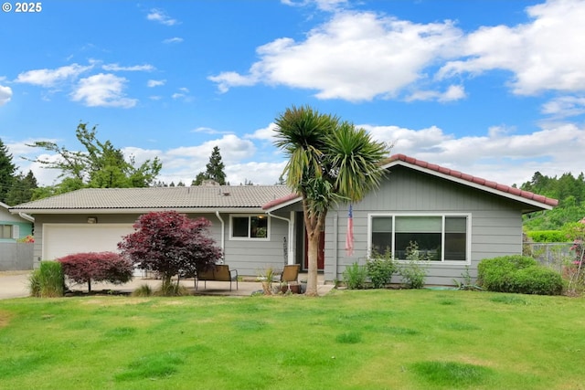 view of front of home featuring a tiled roof and a garage