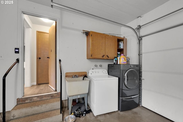 laundry area featuring cabinet space and washing machine and clothes dryer