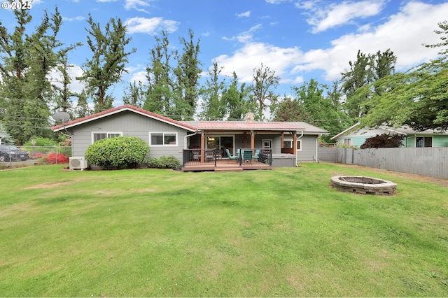 back of house featuring a fire pit, a deck, ac unit, and a chimney