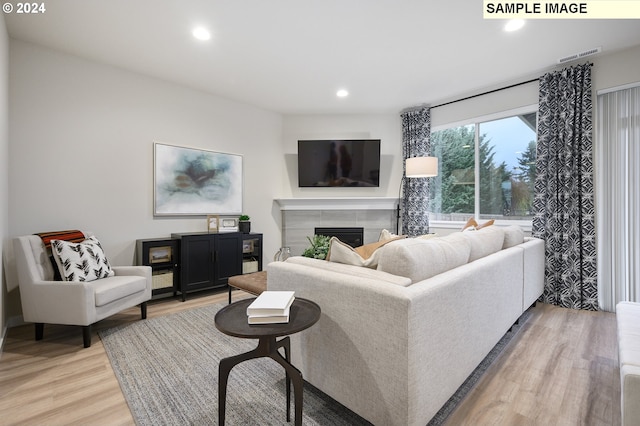 living room with hardwood / wood-style floors and a fireplace