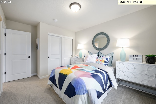 bedroom with light colored carpet and a closet