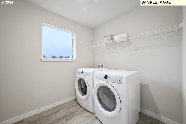 laundry room featuring independent washer and dryer and wood-type flooring