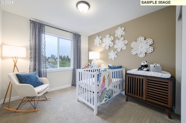 carpeted bedroom with a nursery area