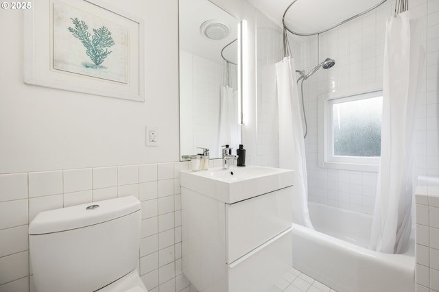 1720 NW Hoyt St, Portland, OR 97209 - full bathroom with tile walls, shower / tub combo with curtain, and vanity