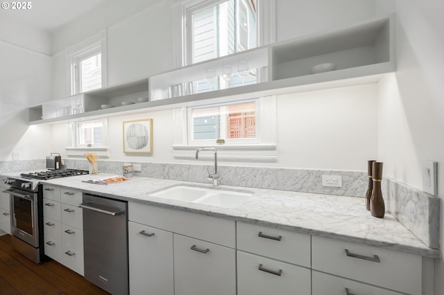 1720 NW Hoyt St, Portland, OR 97209 - kitchen with appliances with stainless steel finishes, open shelves, dark wood-style floors, white cabinets, and light stone counters