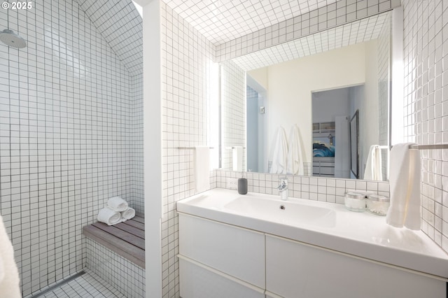 1720 NW Hoyt St, Portland, OR 97209 - bathroom featuring tile walls, vanity, tile patterned floors, tiled shower, and decorative backsplash