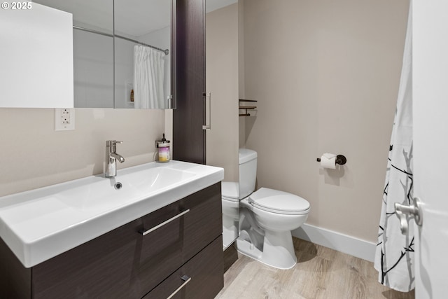 bathroom featuring hardwood / wood-style flooring, vanity, and toilet