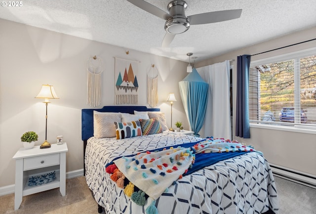 carpeted bedroom featuring ceiling fan, a textured ceiling, and a baseboard heating unit