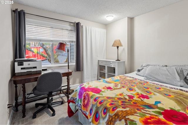 bedroom featuring carpet flooring, a textured ceiling, and a baseboard heating unit