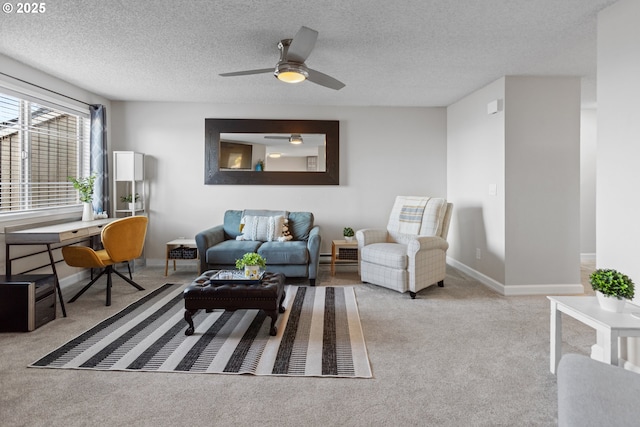 carpeted living room featuring ceiling fan and a textured ceiling