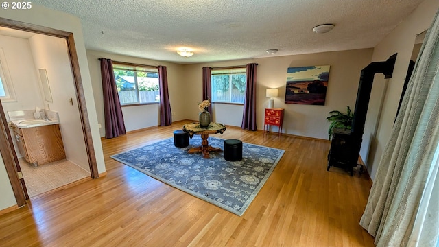 4845 Elizabeth St N, Keizer, OR 97303 - living area with a textured ceiling, light wood-type flooring, and baseboards