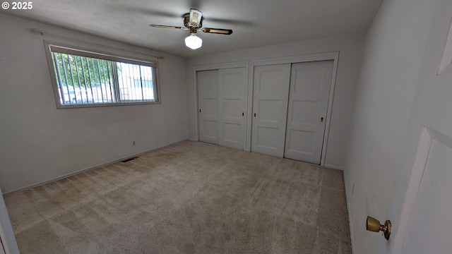 4845 Elizabeth St N, Keizer, OR 97303 - unfurnished bedroom with multiple closets, carpet floors, and a ceiling fan