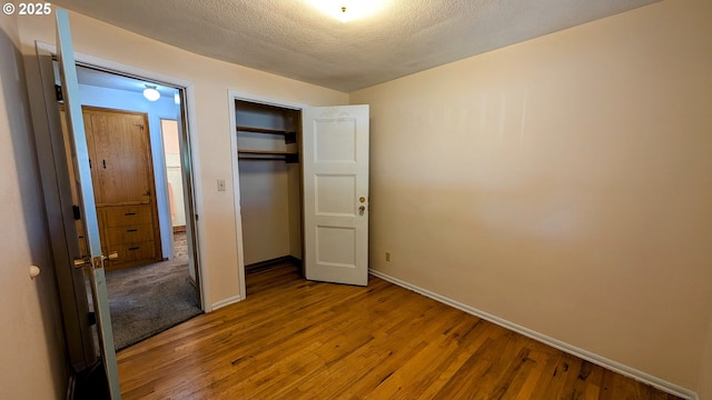 4845 Elizabeth St N, Keizer, OR 97303 - unfurnished bedroom with baseboards, wood finished floors, a closet, and a textured ceiling
