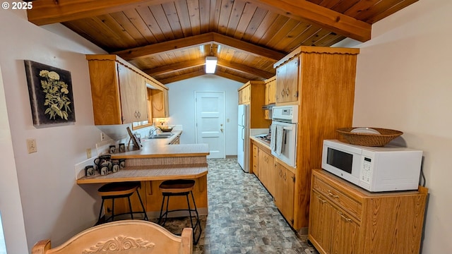 4845 Elizabeth St N, Keizer, OR 97303 - kitchen featuring white appliances, a sink, a peninsula, light countertops, and wooden ceiling
