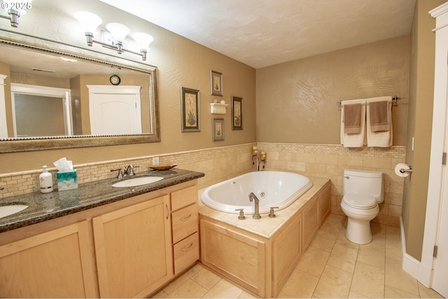34103 Adler Ln, Creswell, OR 97426 - bathroom with tile walls, a whirlpool tub, toilet, double vanity, and tile patterned floors