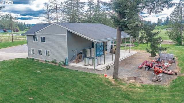 34103 Adler Ln, Creswell, OR 97426 - rear view of house featuring a yard, driveway, and roof with shingles
