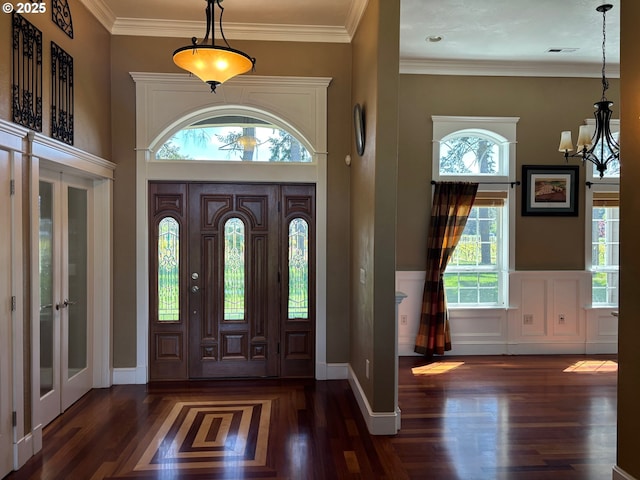 34103 Adler Ln, Creswell, OR 97426 - foyer entrance with french doors, wood finished floors, a chandelier, wainscoting, and ornamental molding