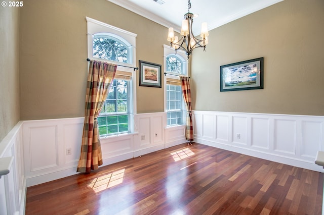 34103 Adler Ln, Creswell, OR 97426 - unfurnished dining area featuring a chandelier, plenty of natural light, crown molding, wood finished floors, and a wainscoted wall