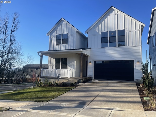 view of front facade featuring a porch, a garage, and a front yard