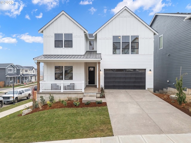 modern farmhouse style home featuring board and batten siding, concrete driveway, a front yard, covered porch, and a standing seam roof