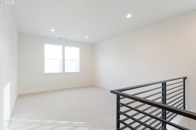 unfurnished room featuring recessed lighting, baseboards, and light colored carpet