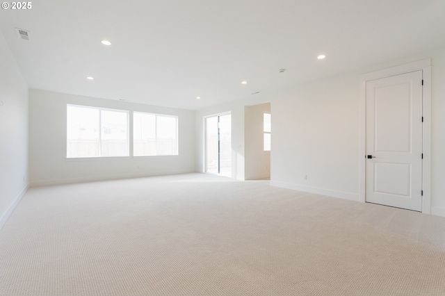 spare room featuring recessed lighting, visible vents, and light carpet