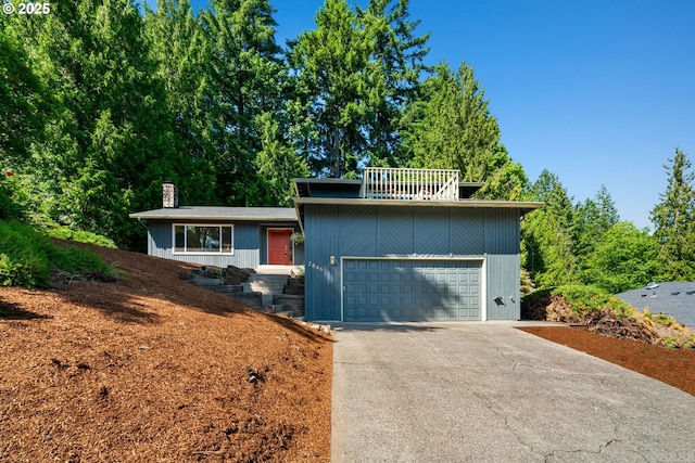2845 SW Raleighview Dr, Portland, OR 97225 - view of front of house with driveway and a chimney